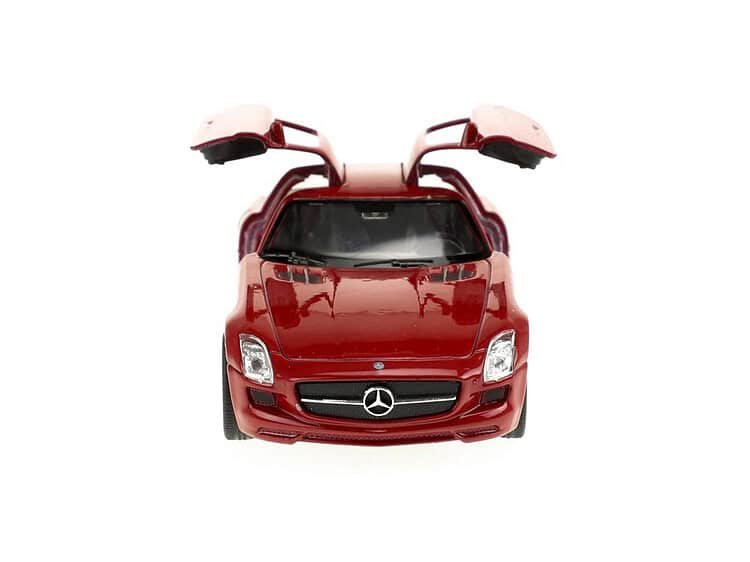 Red children's electric car with gull-wing doors, perfect for playtime.