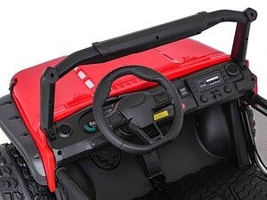 Bright red child's electric ride-on car with realistic dashboard and steering wheel.
