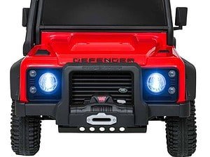 1. Masină electrică pentru copii, model Defender, cu luminile aprinse și roți robuste.