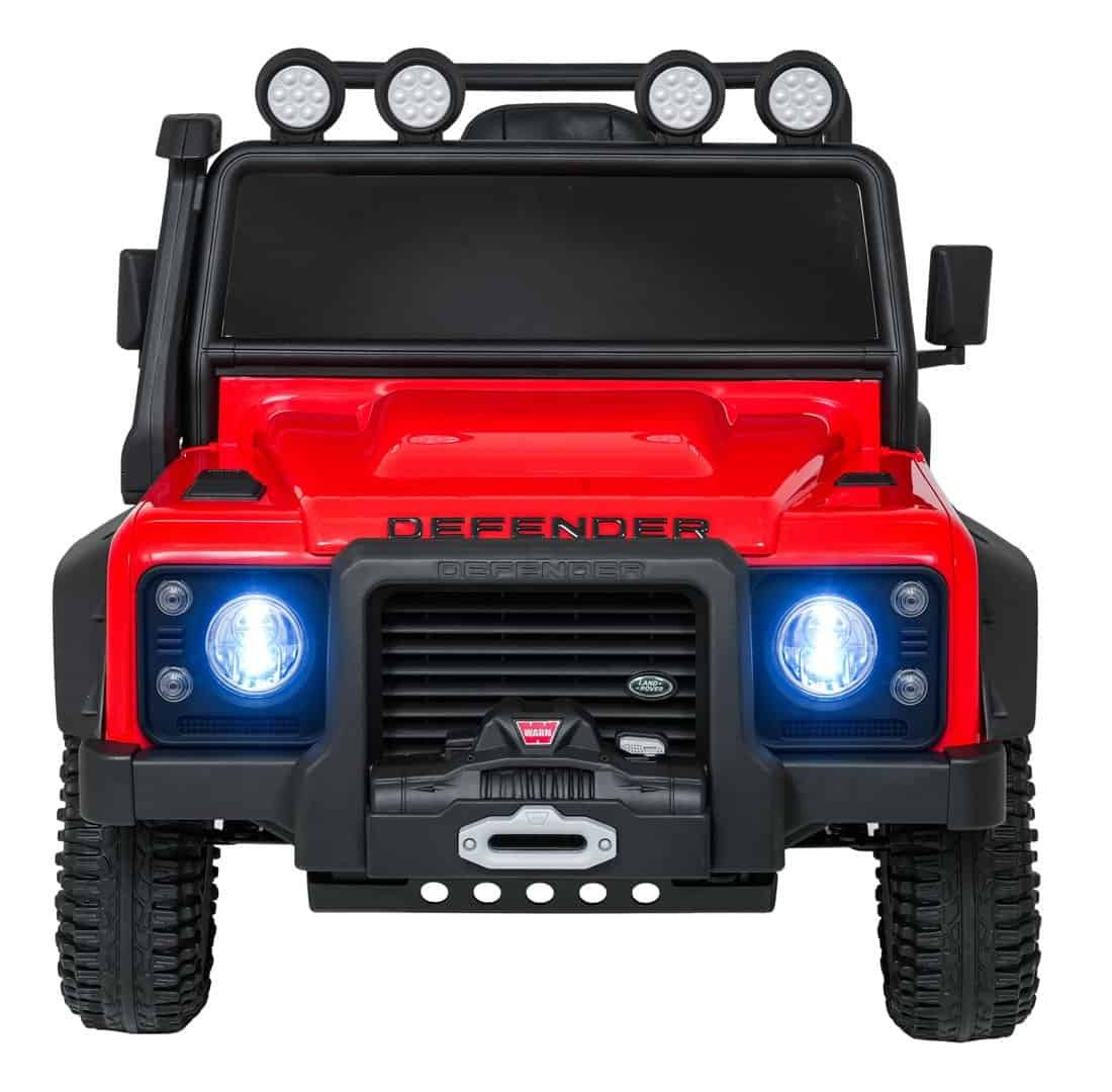 1. Masină electrică pentru copii, model Defender, cu luminile aprinse și roți robuste.