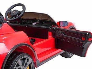 Red electric toy sports car with detailed dashboard and open door, perfect for children.